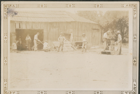 Group of men working outside barn (ddr-densho-316-286)