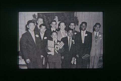 (Slide) - Image of group of young men in suits in front of a statue (ddr-densho-330-151-master-0c61e87d65)