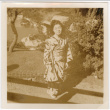 Tomoye (Nozawa) Takahashi in kimono standing in garden (ddr-densho-426-2141)