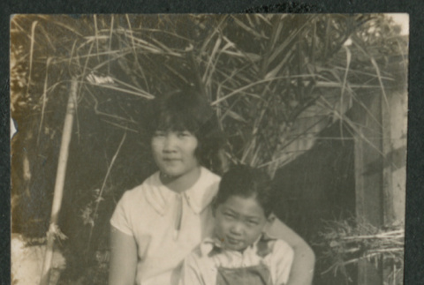boy and girl sitting on bench (ddr-densho-378-690)