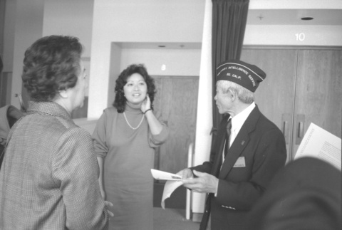 Man in Military Intelligence Service cap and two others (ddr-densho-1007-555)
