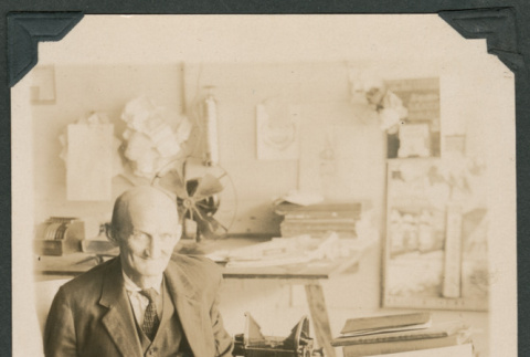 Photo of Mr. McNeil at a desk (ddr-densho-483-319)