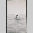 Boy floating on inner tube (ddr-densho-523-189)