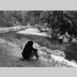 A camper sitting at the edge of a creek (ddr-densho-336-209)