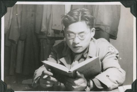 Man in glasses reading (ddr-ajah-2-499)
