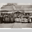 Large group posing in front of building with Japanese and U.S. flags (ddr-ajah-6-726)
