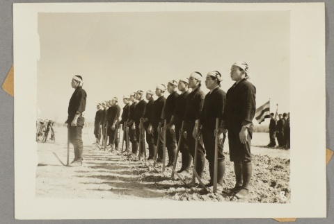 Men standing in a line outdoors (ddr-njpa-13-1537)