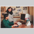Becky Fukuda and staff member working on computer (ddr-densho-506-66)