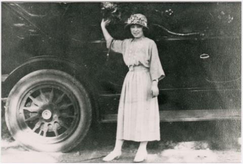 Young woman in front of a car (ddr-densho-353-214)