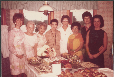 Group of women by table with food (ddr-densho-523-594)