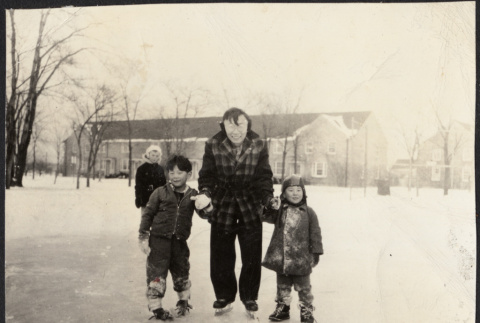 Chester Sakura with two boys on ice skates (ddr-densho-523-171)