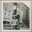 A woman standing on a city street (ddr-densho-298-275)