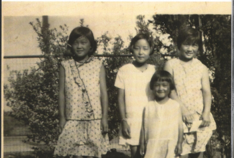 Four children standing outside (ddr-manz-10-133)