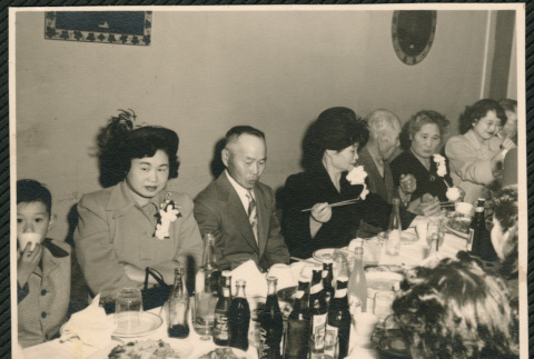 Dinner party, women wearing corsages (ddr-densho-522-757)