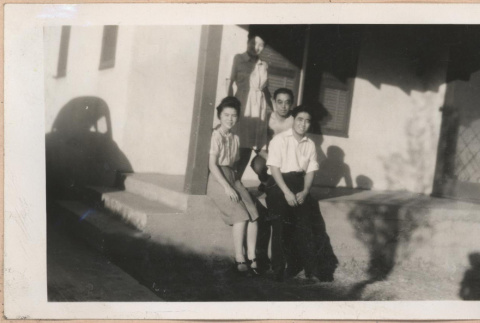 Family on a porch (ddr-manz-10-101)