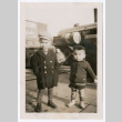 Photo of two children in overcoats on a sidewalk (ddr-densho-483-739)