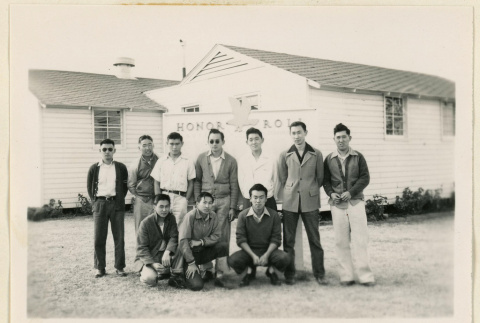 Inductees in front of Honor Roll sign (ddr-densho-37-1879)