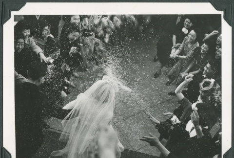 Wedding guests throwing rice on the bride and groom (ddr-densho-300-234)