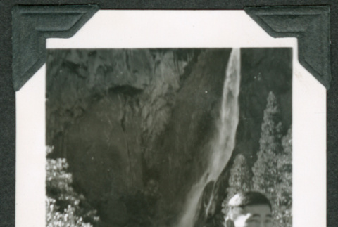 Man standing at base of waterfall (ddr-densho-475-689)