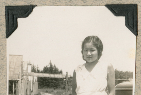 Yukiko Suzuki standing next to car (ddr-densho-383-294)