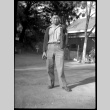 Blurry image of man standing in dirt driveway (ddr-densho-475-79)