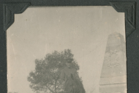 Photo of a man on a horse beside a monument (ddr-densho-483-228)