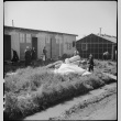 Bedding and clothing in front of barracks (ddr-densho-151-456)