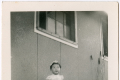 Miki Domoto standing outside barracks (ddr-densho-329-1350)