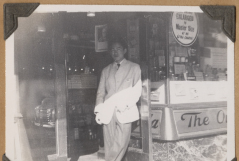 Gary Kikawa poses in a shop doorway (ddr-densho-542-61)