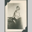 Woman sitting on an outdoor structure (ddr-densho-321-133)