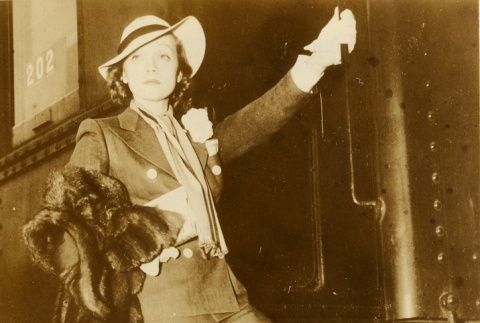 Marlene Dietrich posing while boarding a train (ddr-njpa-1-198)