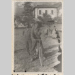 Two men in uniform, one man on bicycle (ddr-densho-466-345)
