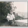 Chester Sakura Sr., with man and woman sitting on log (ddr-densho-523-334)