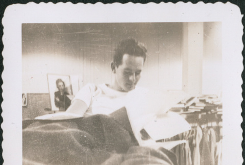 Man laying on bunk reading (ddr-densho-434-473)