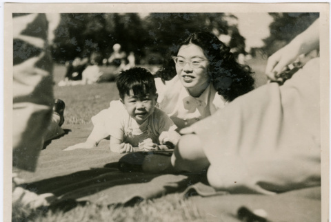 Tomoye and Norman Takahashi at a park (ddr-densho-426-1051)