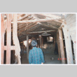 Photo of Kenji Ima entering a barn (ddr-densho-483-13)