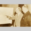 Carl Vinson reviewing a map with another man (ddr-njpa-1-2319)