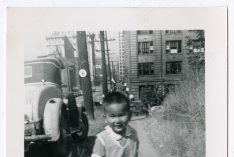 Photo of a child walking down a sidewalk (ddr-densho-483-734)