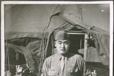 Soldier in front of tents (ddr-densho-201-488)