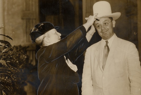 Woman putting a hat on a man's head (ddr-njpa-2-416)