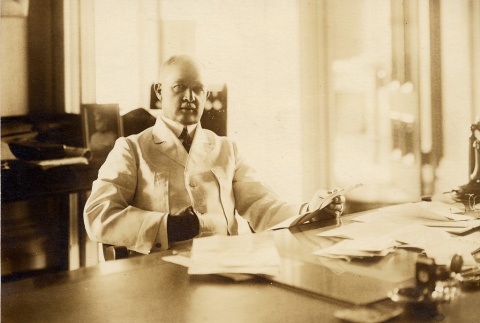 Man posing at his desk (ddr-njpa-2-650)
