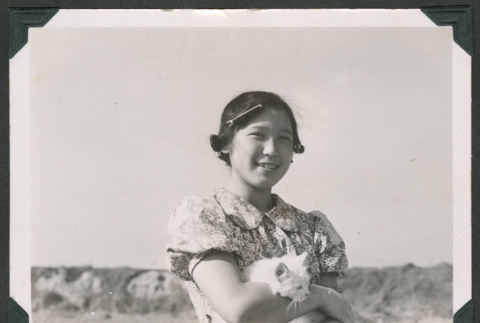 Suzie Shiota carrying cat (ddr-densho-550-163)
