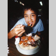 Todd Taniguchi eating dinner (ddr-densho-336-1825)