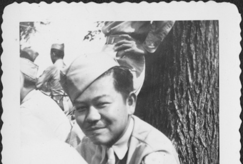 Man sitting by tree (ddr-densho-434-387)