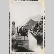 Musical band of soldiers playing for group by tents including young girl (ddr-densho-466-637)
