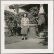 A woman standing in front of a house (ddr-densho-298-298)