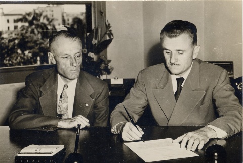 W. Harold Loper signing a document with a Veterans' Administration leader (ddr-njpa-2-628)