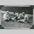Three men sitting outside polishing shoes (ddr-ajah-2-534)