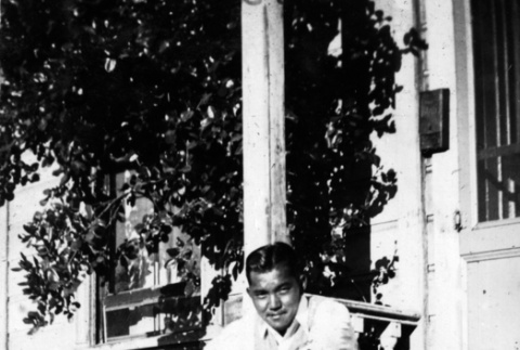John Takakura sitting on steps (ddr-ajah-6-976)