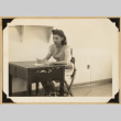 Yuki seated at a desk (ddr-densho-542-536)